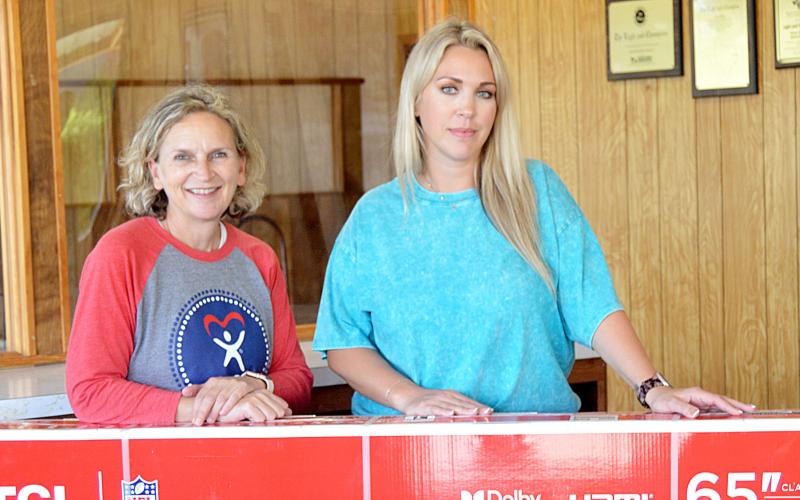 Tonya Harry (left) of CASA of Nacogdoches and Center was the winner in the Light and Champion’s drawing for a 65” TV for its VIP customers. Presenting Harry with her award was Ashley Chandler, General Manager of the Light and Champion. David Danley | Light and Champion