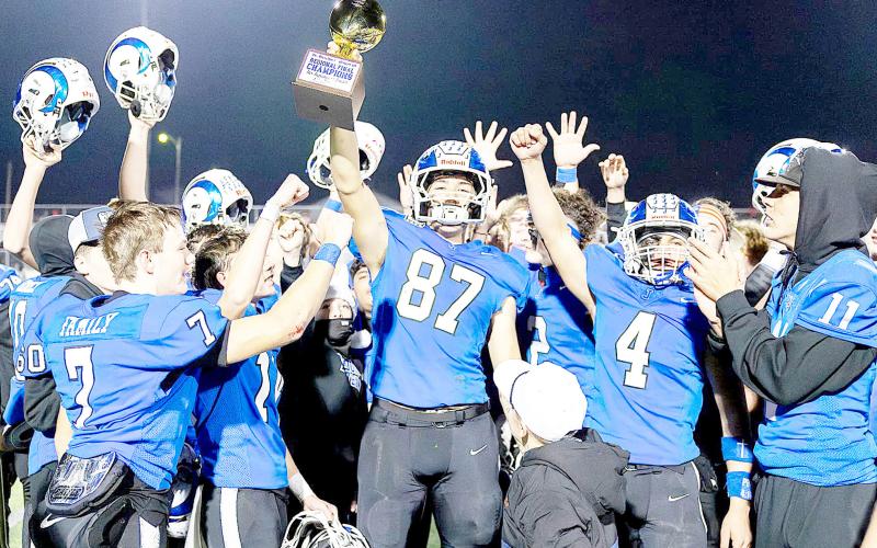 Connor Rios hoists the Regional Championship trophy the Joaquin Rams won in their gridiron contest with the San Augustine Wolves last Friday night. The Wolves prevailed in the teams’ regular season game, but the Rams got their revenge, coming out on top 35-24 in another close game. The Rams will now go up against the Refugio Bobcats tonight at 7:30 in Cypress. Lister Publishing | Light and Champion