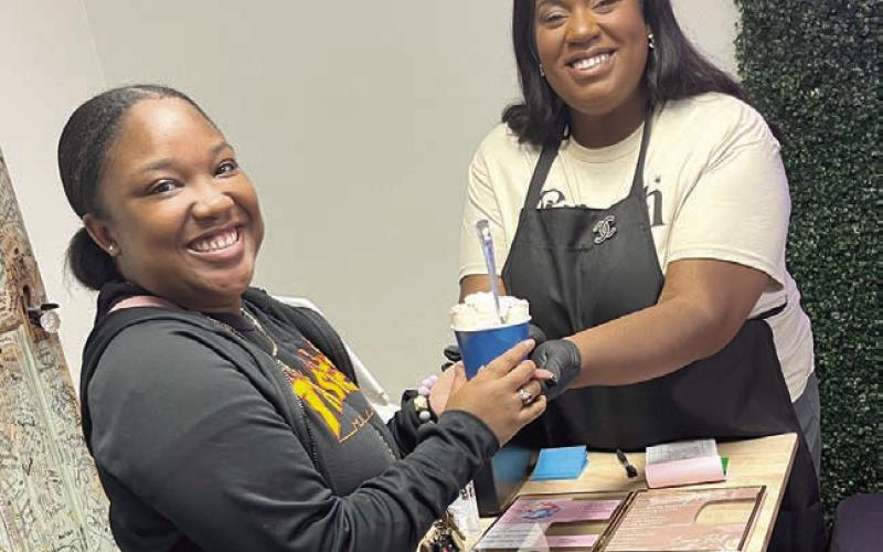 During the Ladies of the Light and Champion event, owner Riley Jo hands out the free ice cream to Maisey, one of the first 14 visitors. Maisey had a ball! Ashley Chandler | Light and Champion