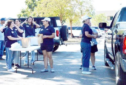 On Monday, Oct. 13, Shelby Savings Banks along with support from BOM Bank, Farmers State Bank, Sabine State Bank and Austin Bank, collaborated to offer $10 hamburger meals for the Texas Banks Community Day of Service. They set up on the Center square with a large grill and a dedicated team preparing food for pickup and delivery. All proceeds from the meal will go directly to Boo’s Battle Fund, which supports individuals and families as they fight their battle with cancer. Zack Clark | Light and Champion