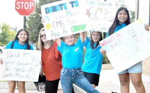 Members of Center Middle School’s My Sister, Myself group took up positions around the Center square last Friday to collect donations towards the group’s annual educational and community service tour. Zack Clark | Light and Champion