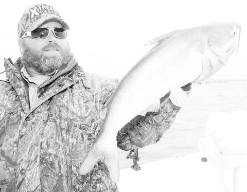 Cedar Creek fishing guide Jason Barber says windy banks and points with stumps and other cover are good places to look for fall and winter catfish in shallow water. Photo by Matt Williams