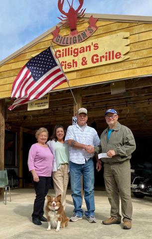  Pictured presenting a check to TBLA, the new owners of Gilligan’s - Jennifer and Derek Nichols (center), with BU Prize Coordinator Linda Ward, and TBLA President Gary Moore.