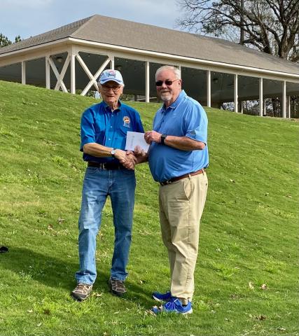 Cypress Bend General Manager Randy Rolland (right) presents TBLA BU Chair Ted Dove with certificates for a golf one year membership to the newly renovated golf course and two golf/accommodation weekend packages that will be auctioned at the Bass Unlimited Banquet.