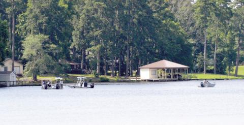 Texas game wardens, along with local law enforcement officers and volunteers, search an area of Lake Timpson where a drowning victim’s kayak capsized. David Danley | Light and Champion
