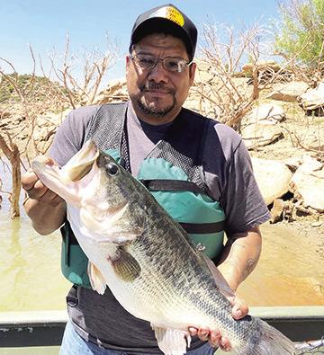 Ross Gomez with the 13.22 pound Toyota ShareLunker he caught while fishing from the public dock at Sam Wahl Recreation Area on Lake Alan Henry in February 2023. The fish produced nearly 34,000 fingerlings during its brief stay at the TFFC and was released back into Alan Henry the following April. TPWD Photo