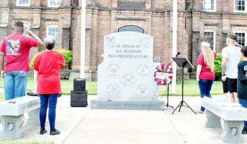 Members of VFW Post 8904 and Auxiliary offer a salute during the post’s observance of Women in Service Day. Zack Clark | Light and Champion
