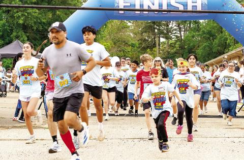 Participants in the first annual Superheroes for Autism 5K race and walk burst across the starting line in the parking lot of Center Missionary Baptist Church. The event was staged to raise awareness of autism and as a fundraiser for Uniting Pieces, a group organized to offer support and resources to families with children with autism. See back page for more pictures. Abram Morales | Light and Champion