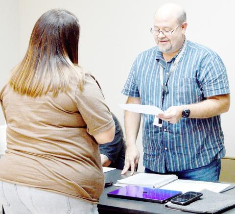 Julie Bass is sworn in as the newest member of the Joaquin city council by new Mayor Rusty Wilson, whose former seat Bass is filling. David Danley | Light and Champion