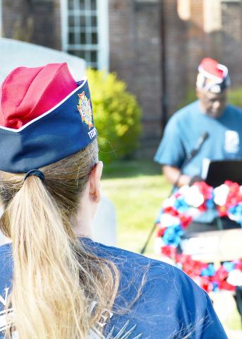 VFW Post 8904 member Mary Roberts stands at attention while Post Commander Richard Lundie memorializes the service of American armed forces members in Operation Allied Force in Kosovo in 1999. David Danley | Light and Champion