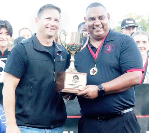 B.J. Muschalek of Texas Farm Bureau, (left) presents Shelbyville High School principal Mario Osby with the 2025 Lone Star Cup award in a ceremony held on Friday, Sept. 26. The Dragon Yearbook