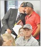 Tenaha City Chief of Police Jake Metcalf (right) consults with his attorney during a city council meeting deliberating possible disciplinary action against him. David Danley | Light and Champion