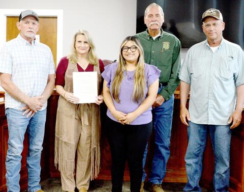 Lizzet Mendoza of the Family Crisis Center of East Texas (center) joined commissioners (from left) Shannon Metcalf, Tom Bellmyer and Stevie Smith and County Judge Allison Harbison to declare October Domestic Violence Awareness Month in Shelby County. Zack Clark | Light and Champion