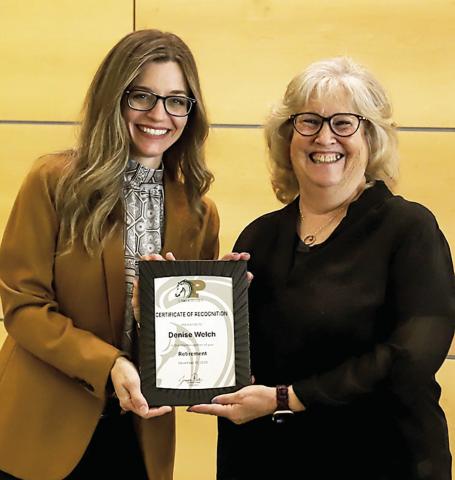 Dr. Jessica Pace, President of Panola College (left), presents recent retiree Denise Welch with a plaque commemorating her 17 years of ser - vice to the college. Submitted | Light and Champion