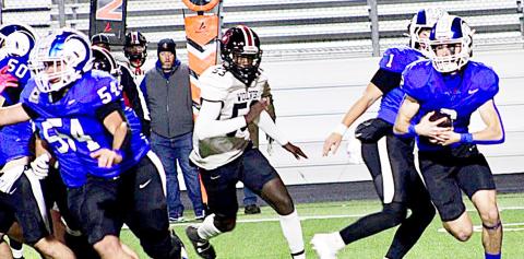 Cooper Bragg takes the handoff from Trenton Runnels (1) while Karson Rogers (54) pulls out to lead the blocking for him while a San Augustine Wolf pursues from behind. SAVANNAH JORDAN JHS | LIGHT AND CHAMPION