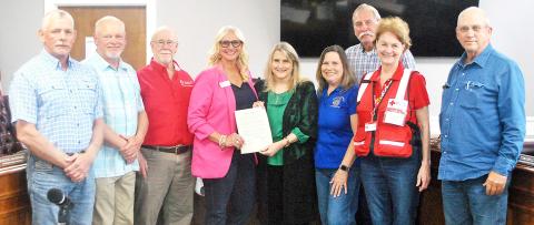 Kimberly Klein (center) of the American Red Cross accepts a proclamation from Shelby County Judge Allison Harbison declaring March Red Cross Month. Joining her to represent the Red Cross were Bob Walsh (third from left) and Paula Sponger (second from right). Also taking part in the proclamation were (from left) Comm. Pct. 2 Shannon Metcalf, Comm. Pct. 1 Roscoe McSwain, Pct. 4 Comm. Tom Bellmyer and Comm. Pct. 3 Stevie Smith. Lisa White | Light and Champion