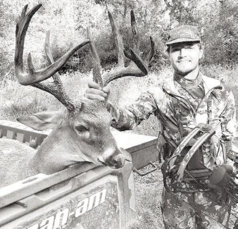 Elkhart archer Luke Johnson, 21, with the 12-point whitetail buck he brought down on his grandfather’s property near Palestine during the Archery Only hunting season. The deer is believed to be 6 1/2 to 7 1/2 years old and unofficially scored at 163 3/8 B&amp;C.