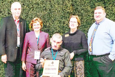 Glenn, Madeline, and Jason Gill (center), recipients of the 2025 Outstanding Tree Farm of the Year Award, are joined by Susan Stutts (right), TFA Senior Director, and Michael Easley (far right), Chair of the Texas Tree Farm Committee, during the Texas Forestry Association’s annual meeting in Nacogdoches. Submitted | Light and Champion