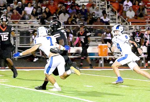 Joaquin’s Zachary Kelley and Jadyn Brown close in on a Wolf runner in action in the Ram’s game in San Augustine last Friday. Kelsi Wood | JHS