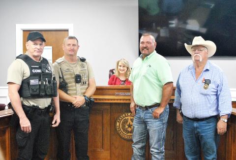 Rowdy Green (second from right) was sworn in as Constable Pct. 4 by Shelby County Judge Allison Harbison to fill an unexpired term during last week’s commissioners court meeting. Green has been a employee of the Pct. 4 commissioner for several years. Also at the ceremony were (from left) new Pct. 5 Deputy Const. Glen Dickerson, Pct. 5 Const. John Pope and Pct. 3 Const. Roy Cheatwood. Lisa White | Light and Champion