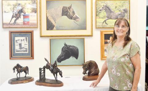 Lisa Myers displays some of her life’s work at the Shelby County Historical Museum where a show featuring Shelby County artists is ongoing. Myers has won many awards and honors for both her paintings and bronze work. David Danley | Light and Champion