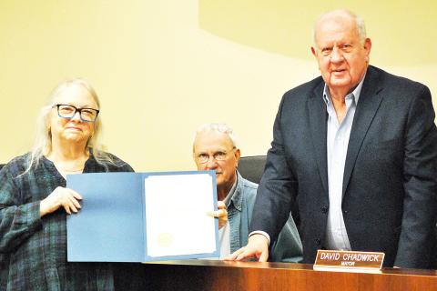 Mayor David Chadwick (right) presents Alease Copelin with a proclamation declaring 2026 the Year of the Volunteer while council member Howell Howard looks on at this week’s Center city council meeting. Zack Clark | Light and Champion