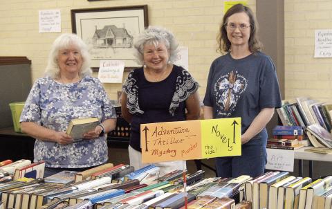The Fannie Brown Booth Memorial Library is holding its Spring Book sale this week through Saturday. Lines formed around the building for opening day, but there are still plenty of books in all sorts of categories available. Assisting librarian Sandra Davis (left) with the sale on Wednesday were volunteers Tammy Lemoine (center) and Kim Oswalt. David Danley | Light and Champion