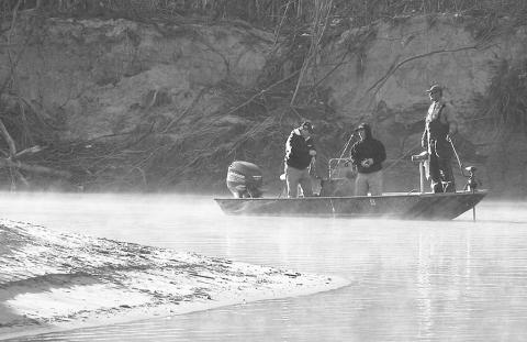 A trio of anglers go gunning for white bass along a sharp bend in the Sabine River on a crisp winter morning. Photo by Matt Williams
