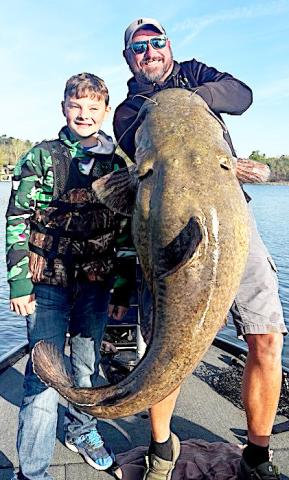 Tucker Sepaugh, 11, reeled in this massive 73-pound flathead catfish on March 19 at Lake Tyler while guided by forward-facing sonar expert William Oliver (right) of Chandler. The fat cat would have been a new state record for junior anglers under 17 had the youth not gotten some badly-needed help while fighting the fish. Photos courtesy Aaron Sepaugh