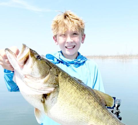 Caden Wilson with the 10.05 largemouth bass he boated on July 31 at Bois d’Arc Lake. Pending certification by TPWD, the fish will be the official junior angler lake record. Photo courtesy Jason Conn | Light and Champion