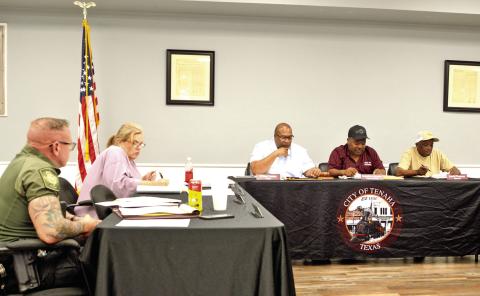 Members of the Tenaha city council review the previous month’s financial reports at its March meeting. David Danley | Light and Champion