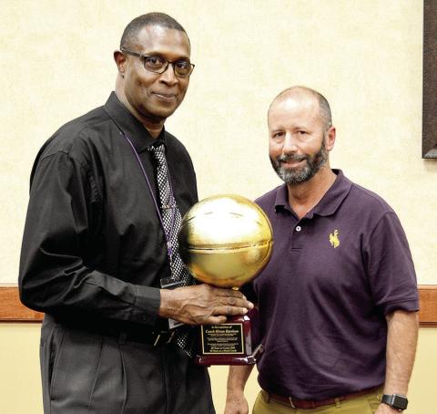 Coach Hiram Harrison (left) was presented an award by CISD Superintendent Jake Henson at the April board meeting to commemorate his 40 years of service as an educator. David Danley | Light and Champion