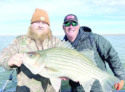 T.J. Jenkins of Yantis was recently notified that the 13.15-pound hybrid striper caught in January at Lake Cooper has been certified a new lake record. The catch beats out the previous record of 11.97 pounds caught by Denise Ann Malone in February 2013. Courtesy Photo, Michael Littlejohn