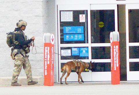 A member of the bomb disposal team from Barksdale Air Force Base prepares to enter the Center Walmart store with his canine to sweep the building for explosives. None were found and following a second sweep by a different canine the store was allowed to re-open. David Danley | Light and Champion