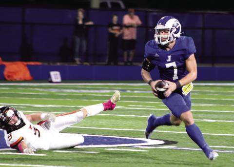 Senior Gauge Jordan rolls to his left seeking an open receiver down field. (Photo by Taylor Bragg)