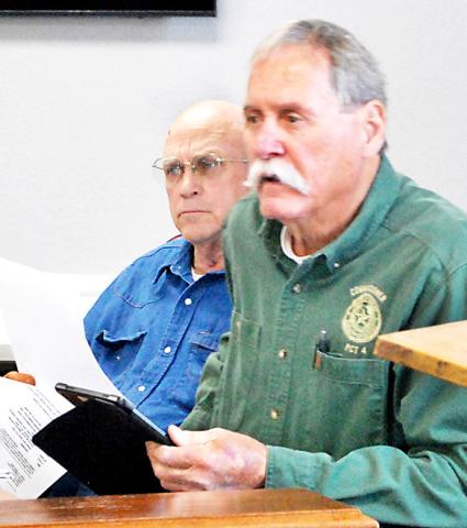 Stevie Smith, Comm. Pct. 3, (left) and Tom Bellmyer, Comm. Pct. 4, listen as Chief Deputy Mike Hanson presents the court with a request concerning outfitting a vehicle for the sheriff’s department. MaggieVaughn | Light and Champion