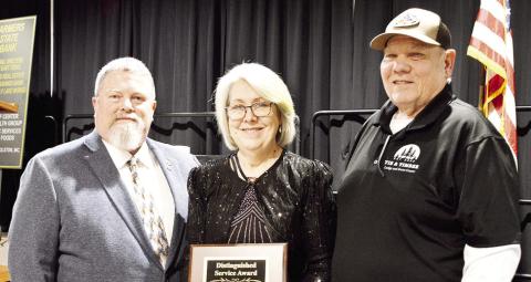 Roger Doyle, (left) presents Paul and Debra Smith with the 2025 Distinguished Service Award. The Smiths have been active active members of the Timpson community where they have owned and operated businesses and where Debra serves as mayor. Zack Clark | Light and Champion