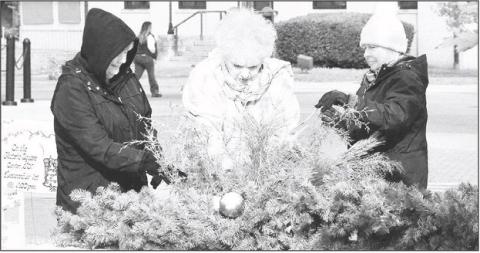 Center Garden Club members (from left) Jennifer Wulf, Vicky Warren and Cherry Jones spruced up the flower boxes around the square earlier this week in anticipation of Center’s holiday celebrations. The annual lighting of the Christmas tree on the historic courthouse square was held Tuesday night and the town’s lighted Christmas parade will be held this Saturday at 6:00 p.m. Zack Clark | Light and Champion