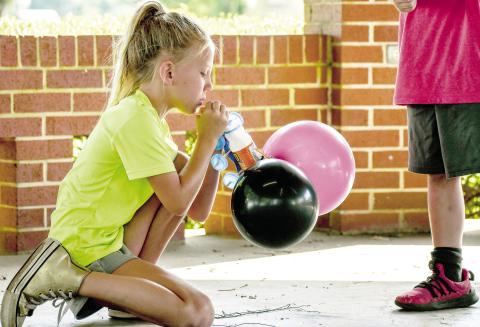 A participant of Timpson ISD’s STEM on the Square inflates a balloon car as part of a demonstration of Newton’s third law of motion. There will be two more events, July 16 and 23. Timpson ISD | Light and Champion