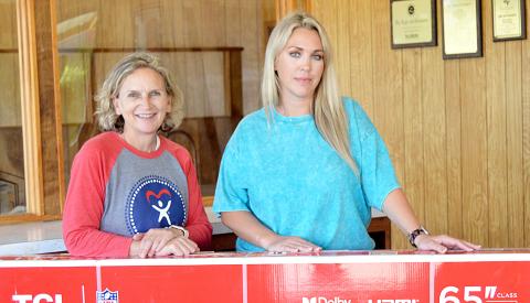 Tonya Harry (left) of CASA of Nacogdoches and Center was the winner in the Light and Champion’s drawing for a 65” TV for its VIP customers. Presenting Harry with her award was Ashley Chandler, General Manager of the Light and Champion. David Danley | Light and Champion