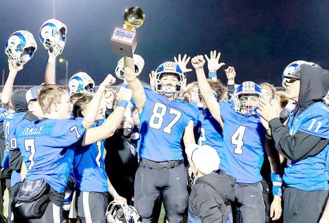 Connor Rios hoists the Regional Championship trophy the Joaquin Rams won in their gridiron contest with the San Augustine Wolves last Friday night. The Wolves prevailed in the teams’ regular season game, but the Rams got their revenge, coming out on top 35-24 in another close game. The Rams will now go up against the Refugio Bobcats tonight at 7:30 in Cypress. Lister Publishing | Light and Champion