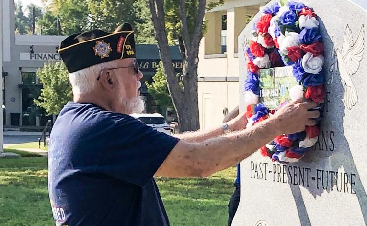 Post Trustee Ike Reeves placed the VFW Memorial Wreath on the Veterans Memorial marker honoring those who gave their lives during the Korean War and for those who served and have since passed. (Leon Aldridge photo/The Light and Champion)
