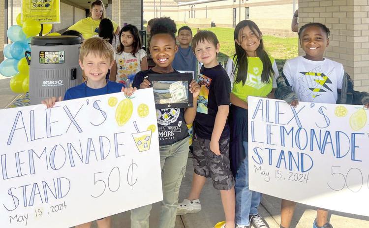 Second-grade students advertising and serving lemonade at F.L. Moffett for the ‘Take a Stand’ against cancer fund raiser. Annika Bloys | The Light and Champion