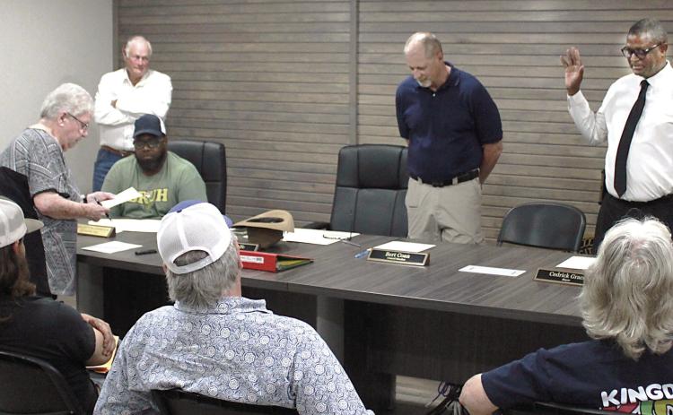 Newly-elected mayor Cedric Grace (right) and council member Bert Coan (center) are sworn in at the May 12 meeting of the Timpson city council. Incumbent Tammy Ramsey was sworn in to another term on the council, as well. Lisa White | Light and Champion