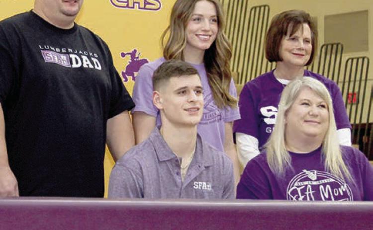 Family and friends gather for photos with Center athlete Lance Wilburn who signed a letter of intent Wednesday to play football for Stephen F. Austin State University.